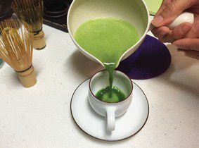 Pouring the freshly whisked matcha for that perfect froth
