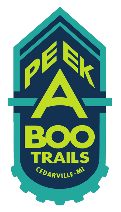 Logo for the Peek-A-Boo Trails which are a biking and hiking trail in between Hessel and Cedarville in the Les Cheneaux Islands area. The logo is reminiscent of a bike logo badge.