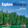 Exploring Michigan magazine from summer 2024 featuring two kayakers on calm blue waters reflecting the cedar trees along the shoreline.